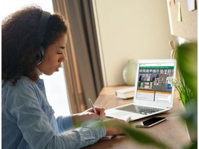 Female student entering JA Inspire on her laptop
