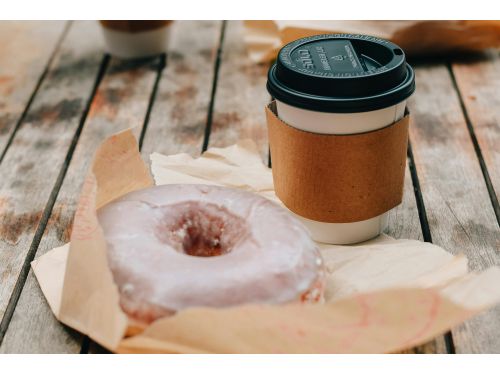 Coffee and donut shown on a table