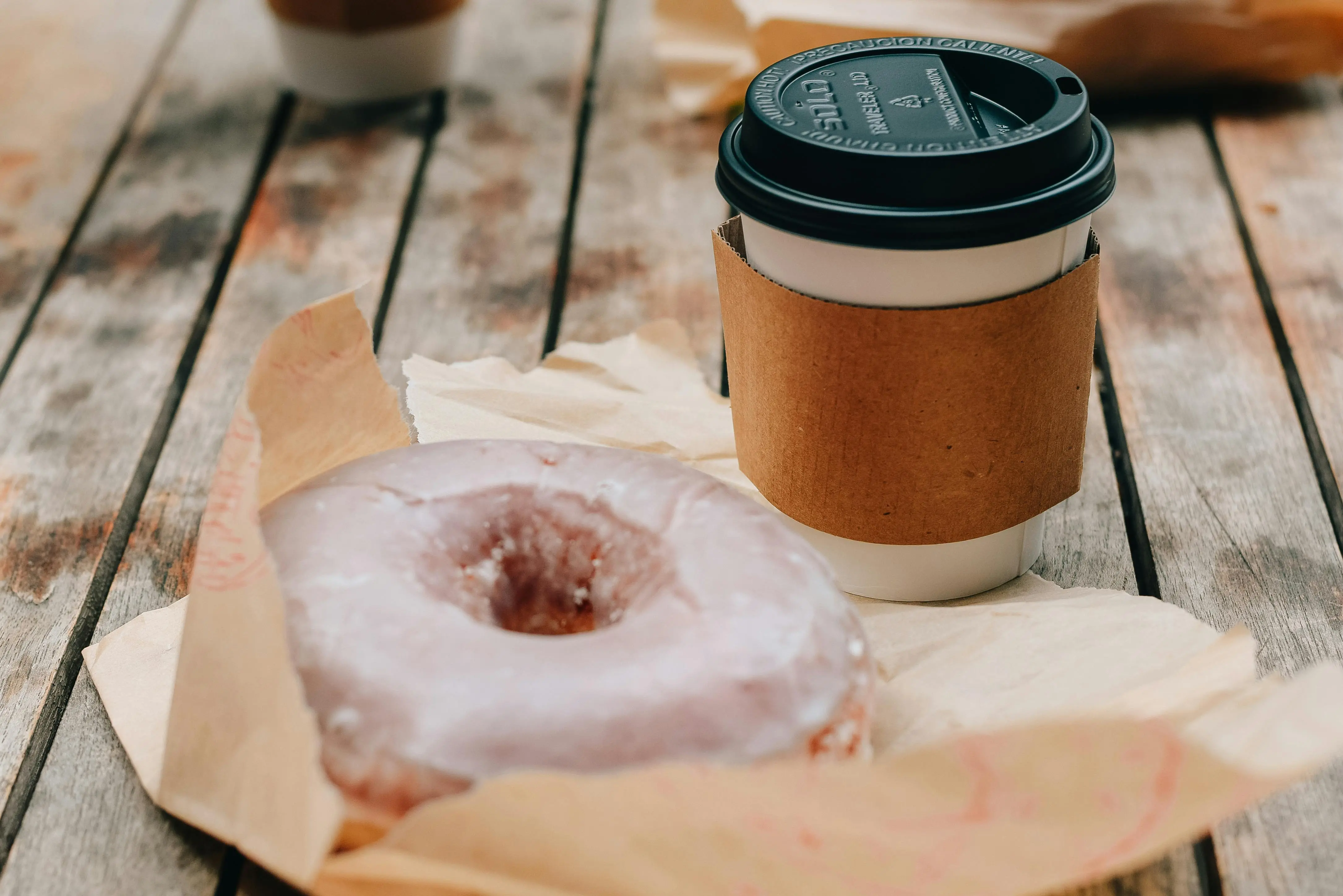 Coffee and donut shown on a table