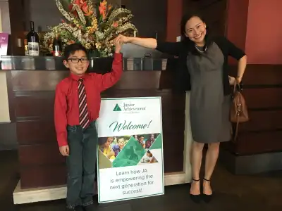 JA participant poses with sign